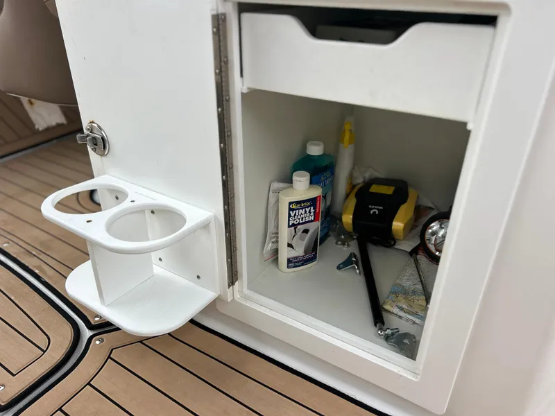 Slide: The Image of 2019 Hurricane SunDeck 2690 OB storage compartment with cleaning supplies and tools. - 34