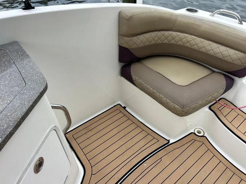 Slide: The Image of 2019 Hurricane SunDeck 2690 OB boat interior with cushioned seating and teak-style flooring. - 35