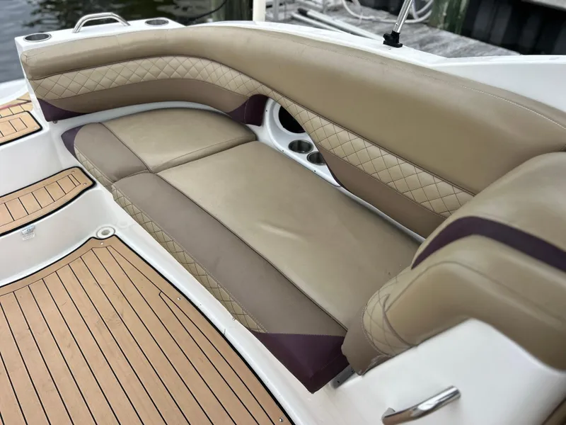 Slide: The Image of 2019 Hurricane SunDeck 2690 OB boat interior with tan leather seating and wood-style flooring. - 36