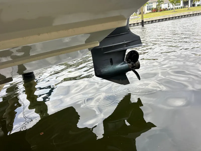 Slide: The Image of 2019 Hurricane SunDeck 2690 OB boat propeller partially submerged in water. - 8