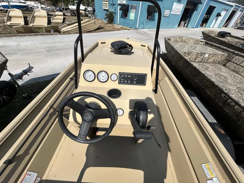 Slide: The Image of 2024 Crestliner 1860 Retriever CC Tunnel boat interior with steering console and gauges. - 10