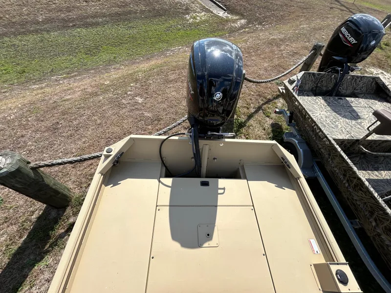 Slide: The Image of 2024 Crestliner 1860 Retriever CC Tunnel boat with outboard motor, parked on grass. - 12
