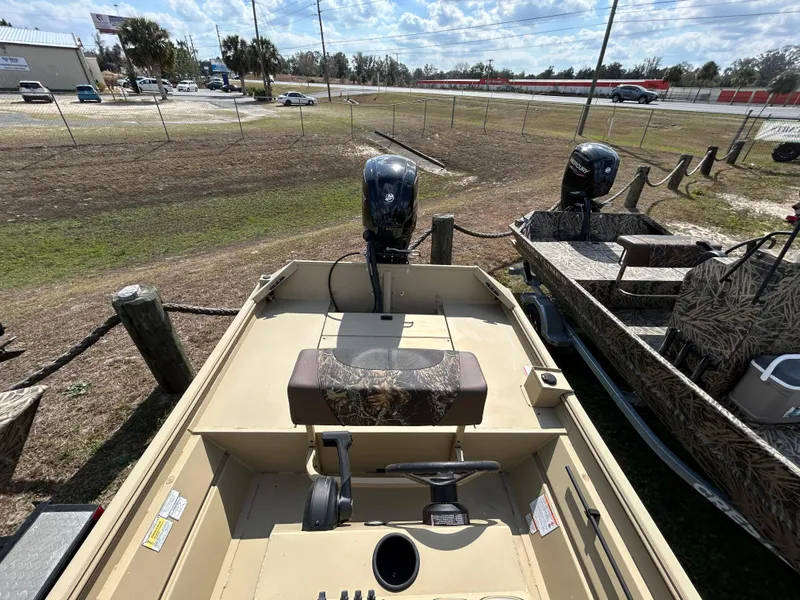 Slide: The Image of 2024 Crestliner 1860 Retriever CC Tunnel boat with outboard motor, parked outdoors. - 15