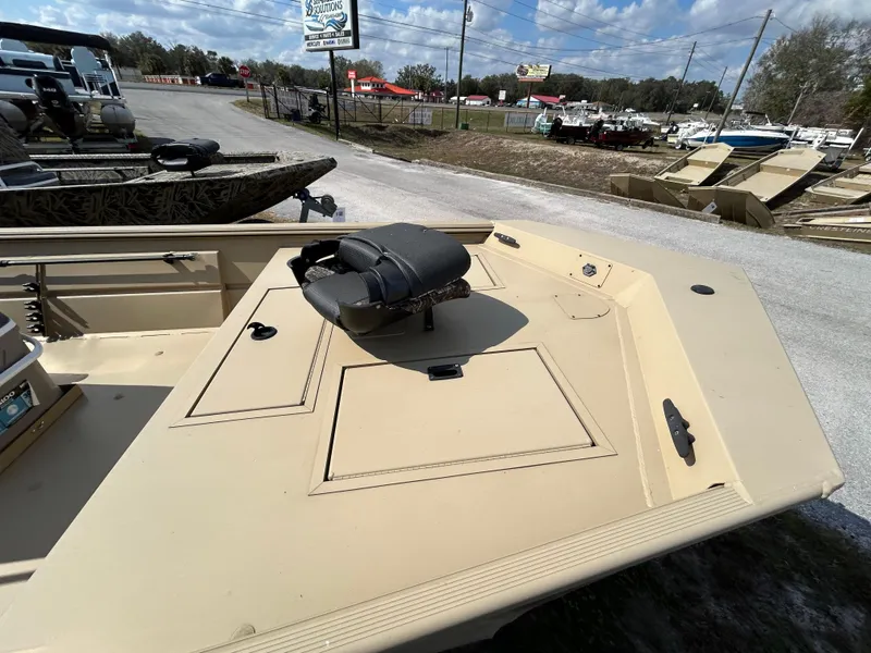 Slide: The Image of 2024 Crestliner 1860 Retriever CC Tunnel boat, beige deck, outdoor display. - 3