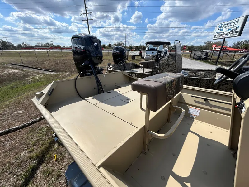 Slide: The Image of 2024 Crestliner 1860 Retriever CC Tunnel boat with Mercury engine, parked outdoors. - 6