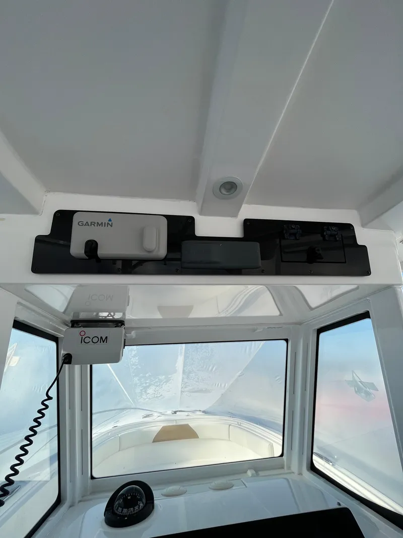 Slide: The Image of 2022 Edgewater 285CC boat interior with Garmin and Icom equipment. - 22