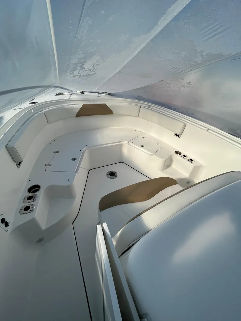 Slide: The Image of 2022 Edgewater 285CC boat interior with seating and storage compartments. - 24