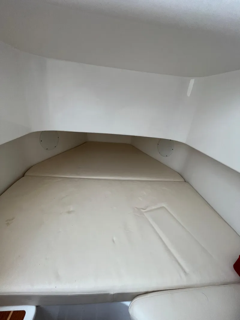 Slide: The Image of Interior cabin of 2022 Edgewater 285CC boat with cushioned seating. - 26