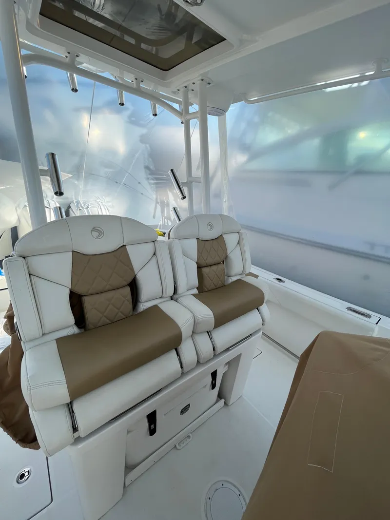 Slide: The Image of 2022 Edgewater 285CC boat interior with cushioned seating and modern design. - 30