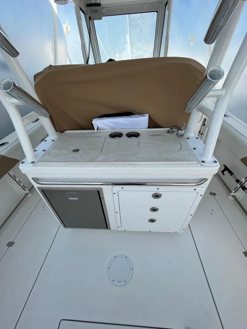 Slide: The Image of 2022 Edgewater 285CC boat interior with storage and seating area. - 31