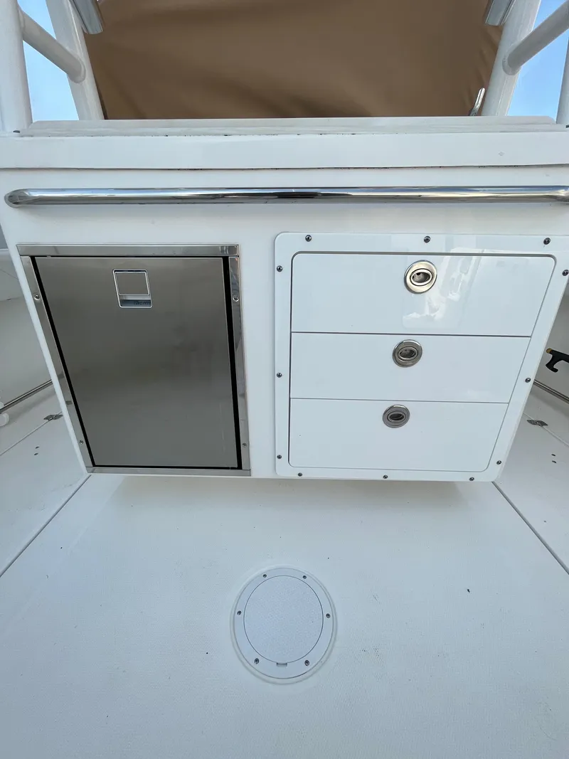 Slide: The Image of Edgewater 285CC 2022 boat interior with storage compartments and stainless steel features. - 33