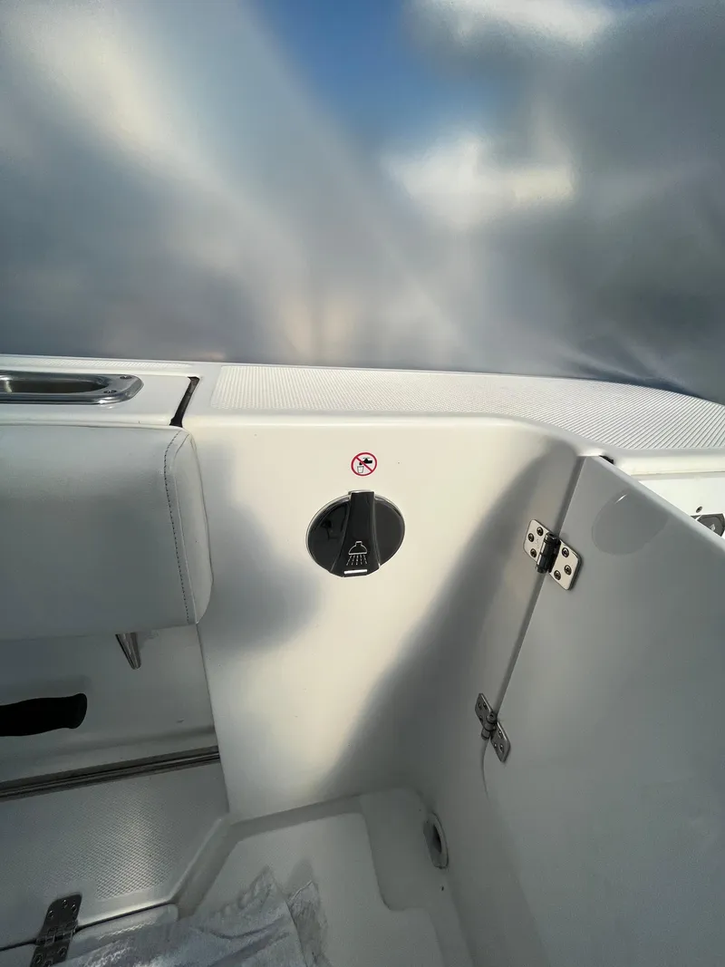 Slide: The Image of 2022 Edgewater 285CC boat interior with sleek white design and modern fittings. - 37