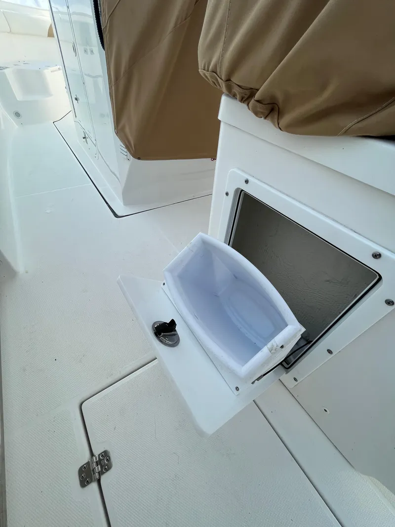 Slide: The Image of 2022 Edgewater 285CC boat storage compartment with open hatch, showcasing interior space. - 39
