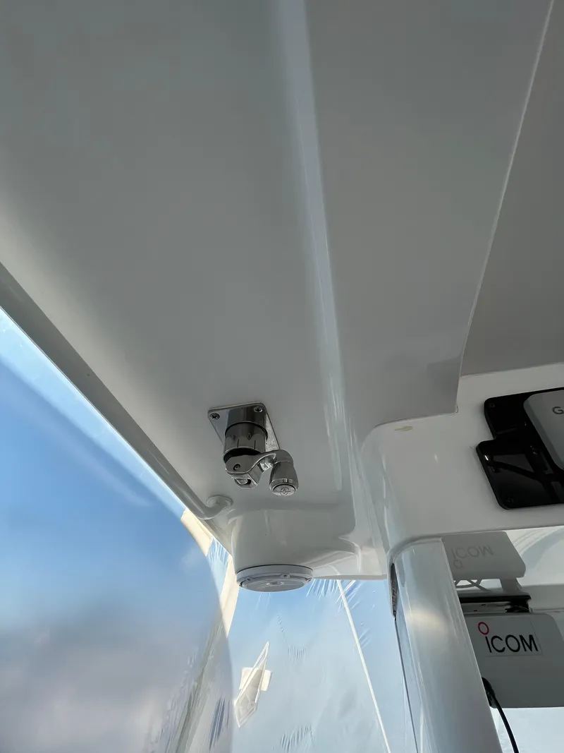 Slide: The Image of Close-up of 2022 Edgewater 285CC boat interior, showing a metal fixture and ICOM device. - 44