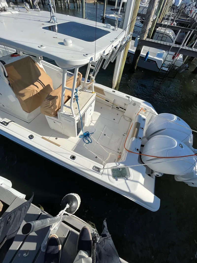 Slide: The Image of 2022 Edgewater 285CC boat docked with twin engines, viewed from above. - 5