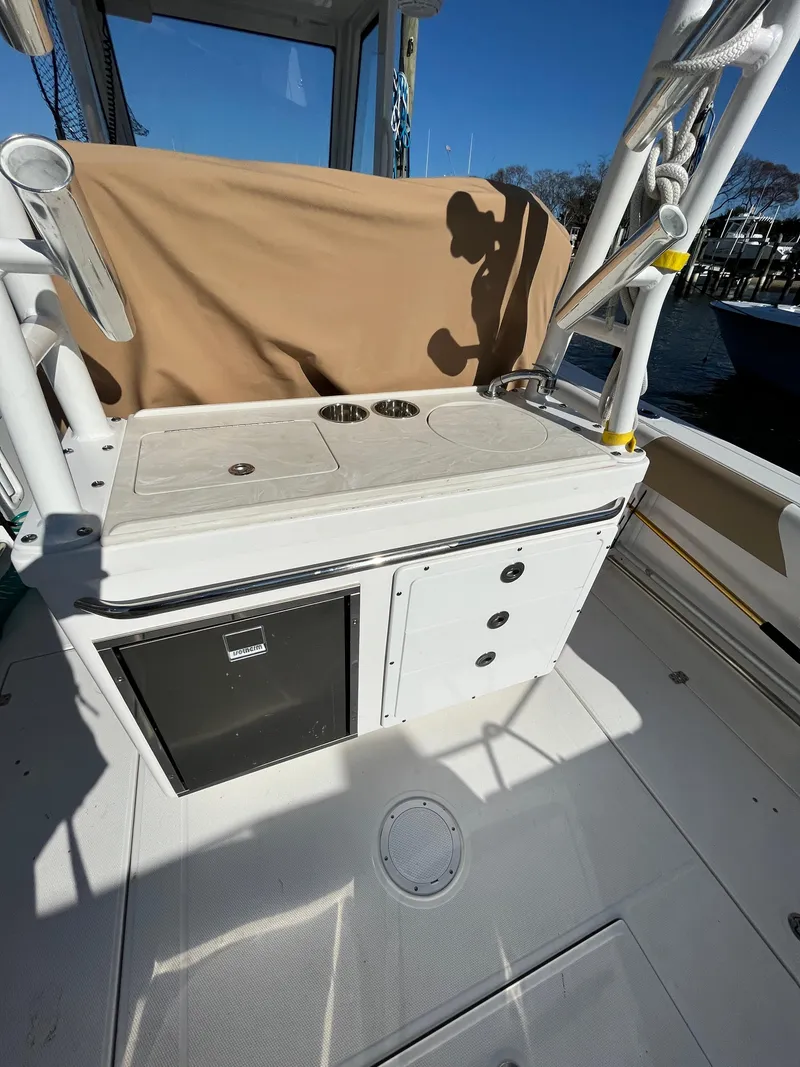 Slide: The Image of 2022 Edgewater 285CC boat interior with storage and seating area. - 7