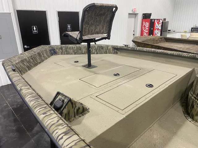 Slide: The Image of 2025 SeaArk Shadow 20 boat interior with camouflage seat and storage compartments. - 6