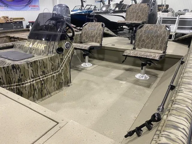 Slide: The Image of 2025 SeaArk Shadow 20 boat interior with camouflage seats and steering console. - 7