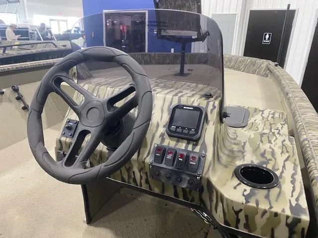 Slide: The Image of 2025 SeaArk Shadow 20 boat dashboard with steering wheel and control panel. - 9