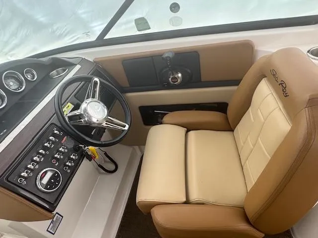 Slide: The Image of 2015 Sea Ray 270 SLX boat interior with steering wheel and beige captain's chair. - 10