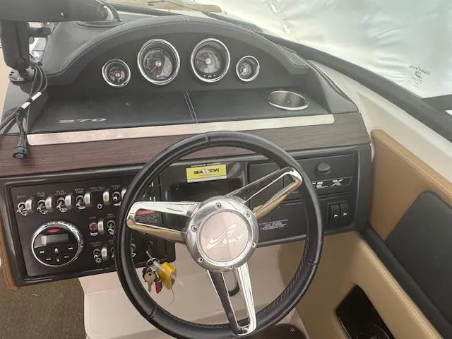 Slide: The Image of 2015 Sea Ray 270 SLX dashboard with steering wheel and control panel. - 13
