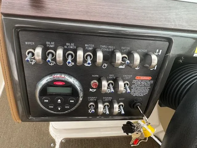Slide: The Image of Control panel of a 2015 Sea Ray 270 SLX boat with various switches and keys. - 15