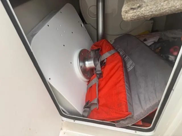 Slide: The Image of Storage compartment in a 2015 Sea Ray 270 SLX with life jacket and equipment. - 23