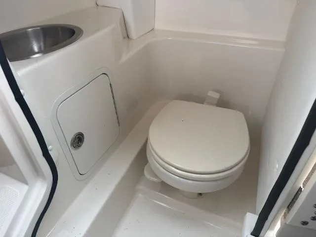 Slide: The Image of 2015 Sea Ray 270 SLX boat bathroom with toilet and sink. - 24