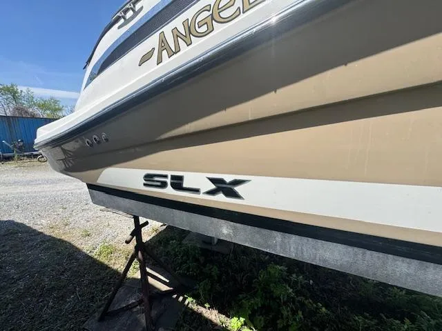 Slide: The Image of 2015 Sea Ray 270 SLX boat on stands, side view with "SLX" logo visible. - 3