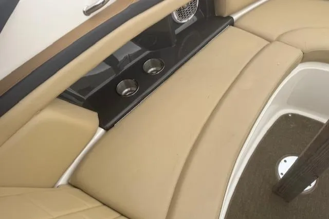 Slide: The Image of 2015 Sea Ray 270 SLX interior with beige seating and cup holders. - 5