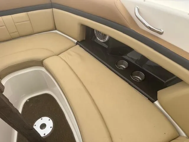 Slide: The Image of 2015 Sea Ray 270 SLX interior with tan seating and cup holders. - 6