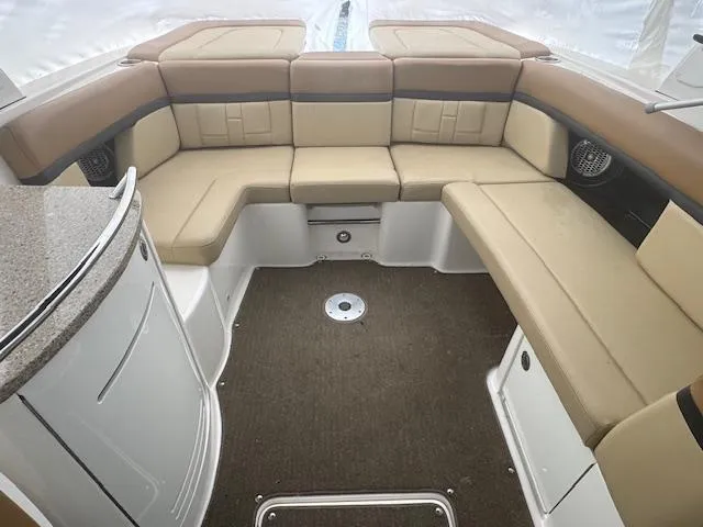 Slide: The Image of 2015 Sea Ray 270 SLX boat interior with beige seating and carpeted floor. - 8