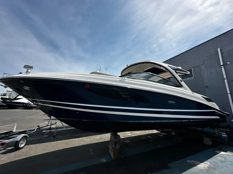 Slide: The Image of 2018 Sea Ray SLX 350 boat displayed outdoors under a clear sky. - 0