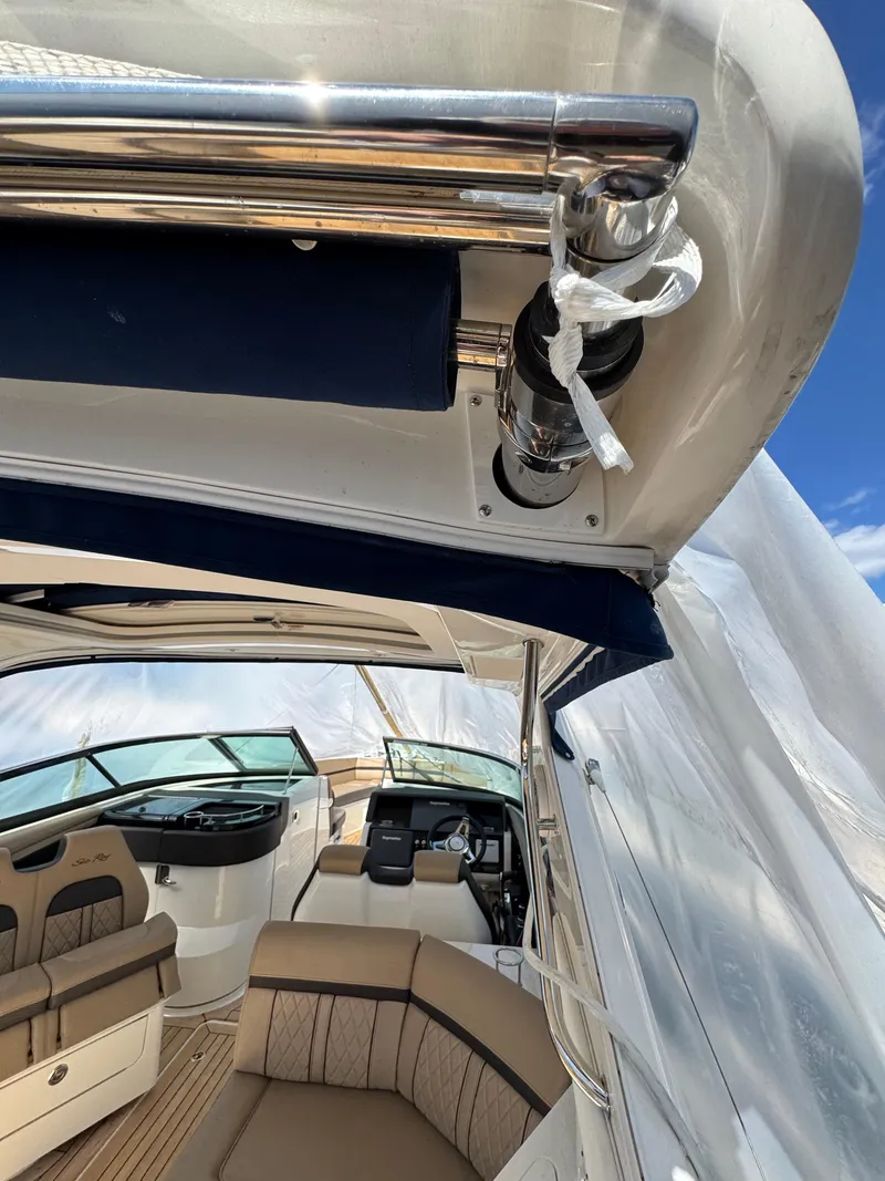 Slide: The Image of 2018 Sea Ray SLX 350 interior with seating and helm, showcasing luxury design. - 10