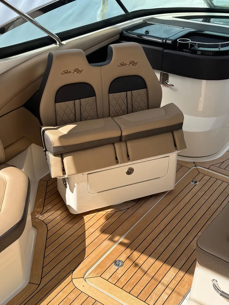 Slide: The Image of 2018 Sea Ray SLX 350 interior with luxurious seating and wood flooring. - 11
