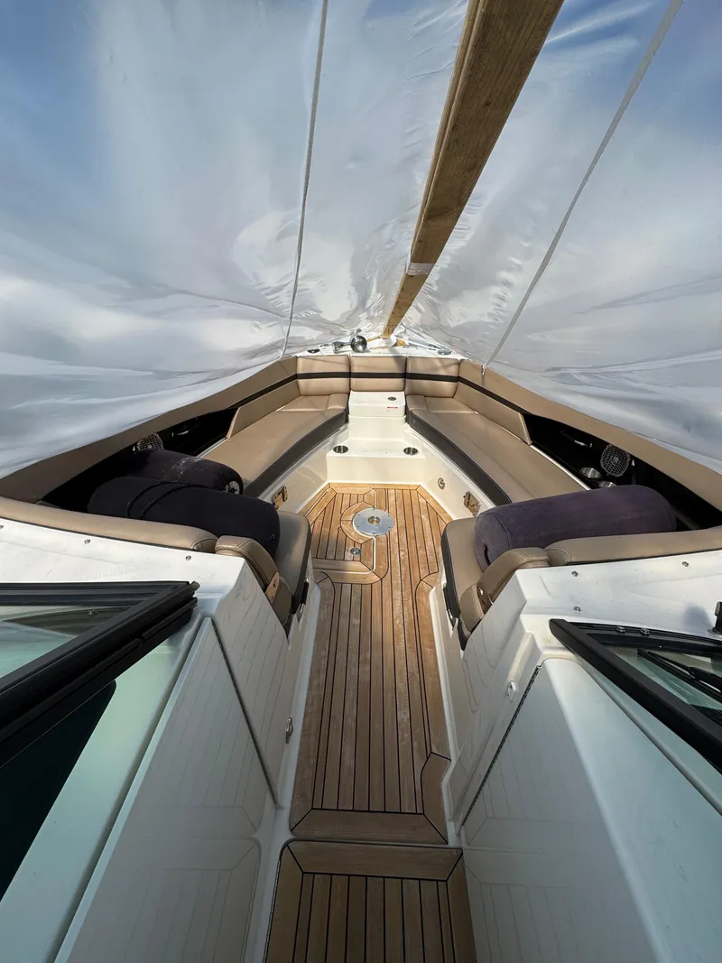 Slide: The Image of 2018 Sea Ray SLX 350 boat interior with wooden deck and seating. - 14