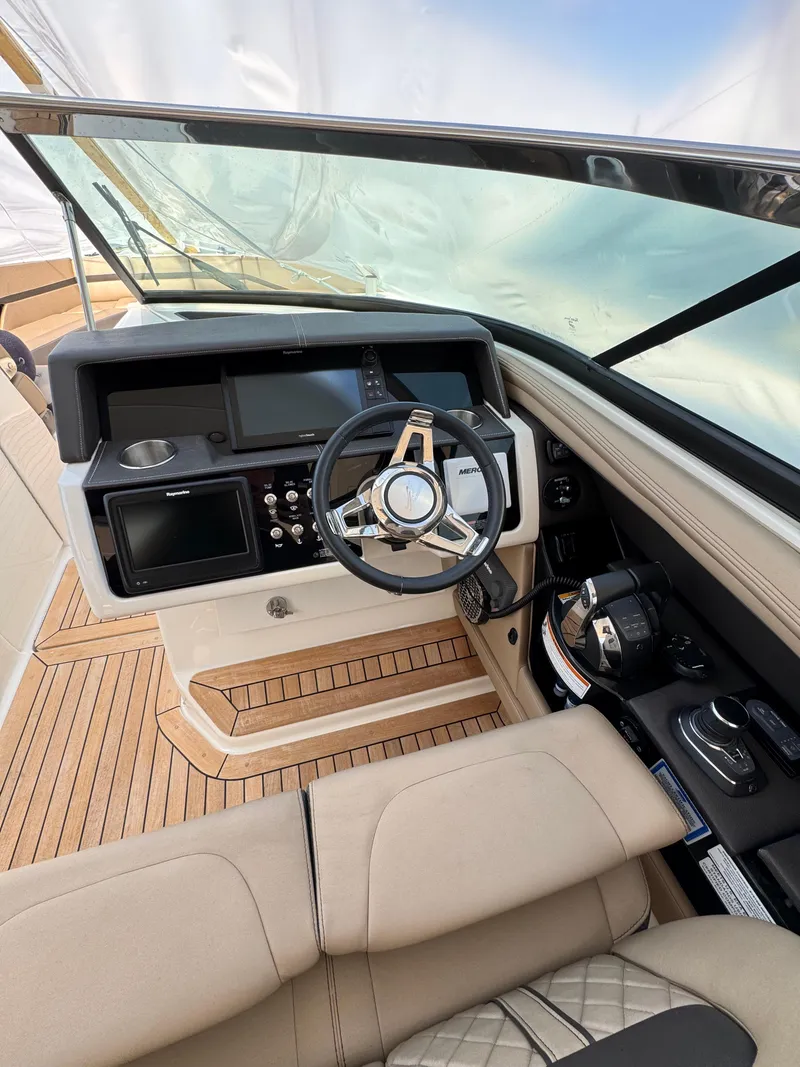 Slide: The Image of 2018 Sea Ray SLX 350 helm with modern controls and luxurious seating. - 16