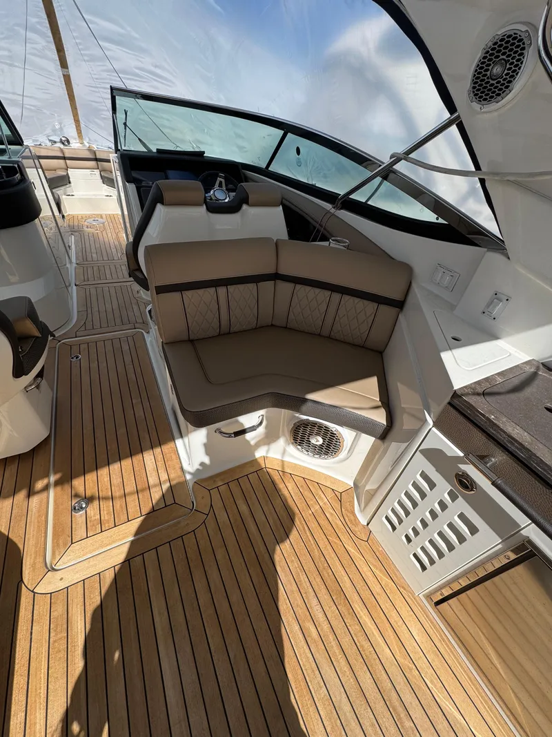 Slide: The Image of 2018 Sea Ray SLX 350 interior with cushioned seating and teak flooring. - 19