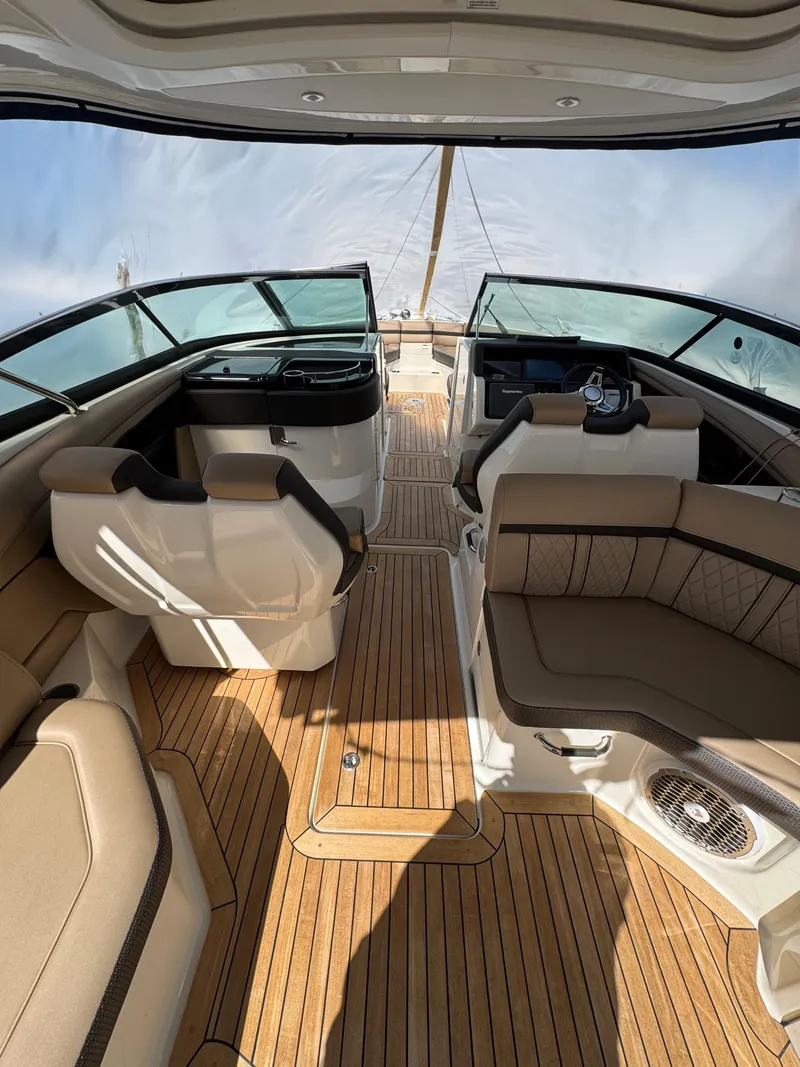 Slide: The Image of 2018 Sea Ray SLX 350 boat interior with luxurious seating and wood flooring. - 20