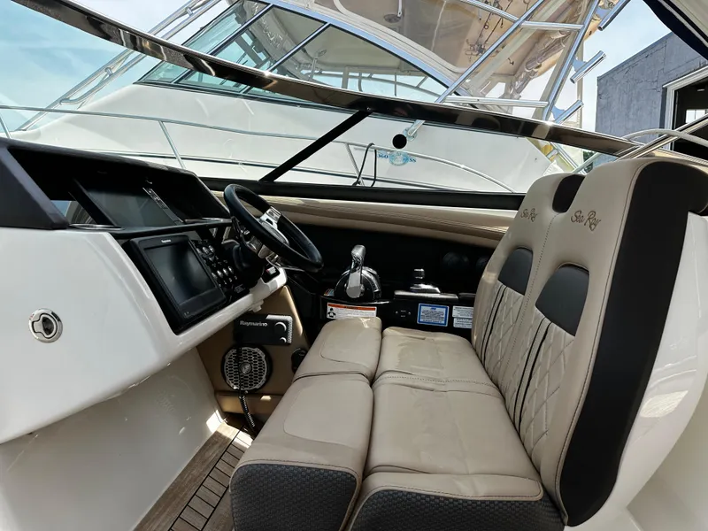 Slide: The Image of 2018 Sea Ray SLX 350 boat interior with steering wheel and seating area. - 7