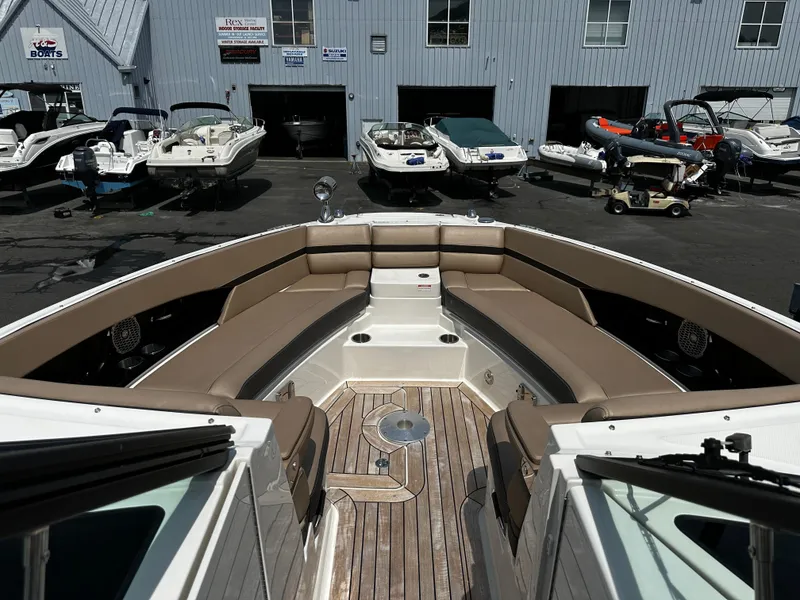 Slide: The Image of 2018 Sea Ray SLX 350 boat interior with spacious seating at a marina. - 8