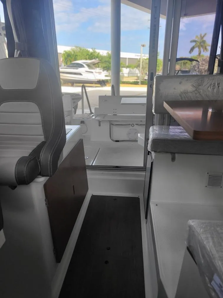 Slide: The Image of Interior view of 2021 Jeanneau NC795 S2 boat, featuring seating and table. - 2