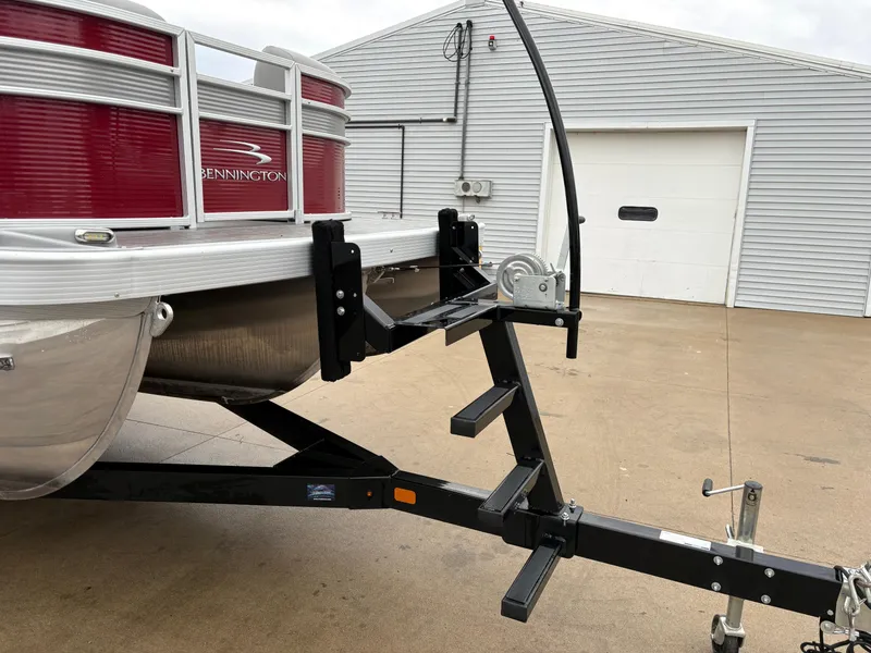 Slide: The Image of 2020 Bennington 22 SLX pontoon boat on trailer near a garage. - 13
