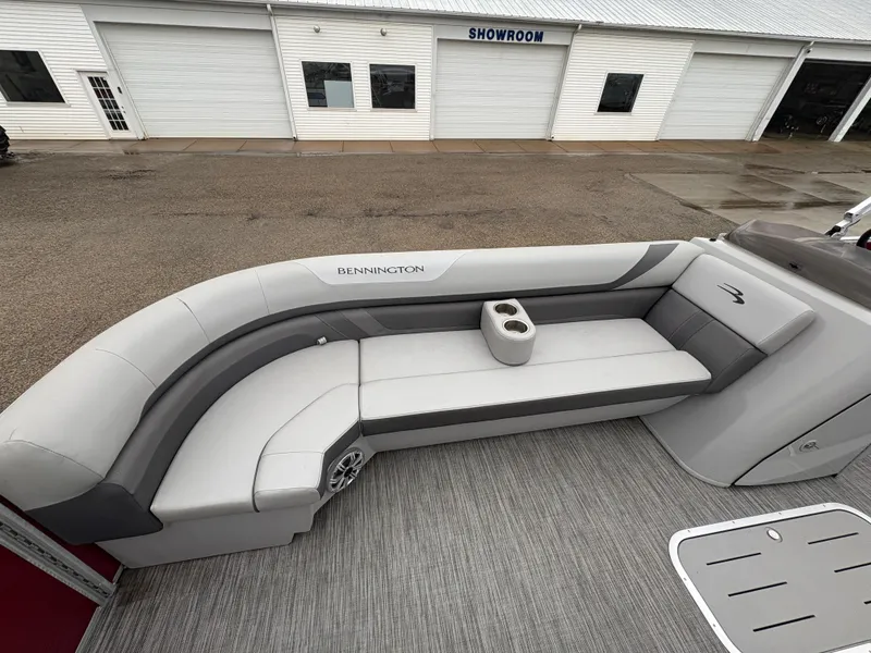 Slide: The Image of 2020 Bennington 22 SLX boat with gray seating, cup holder, and showroom in background. - 15