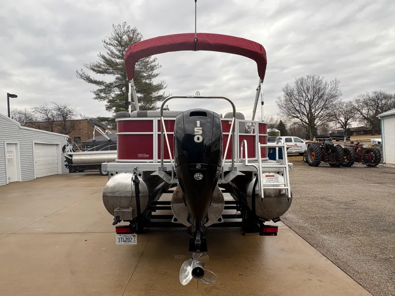 Slide: The Image of 2020 Bennington 22 SLX pontoon boat with red canopy and powerful outboard motor. - 2