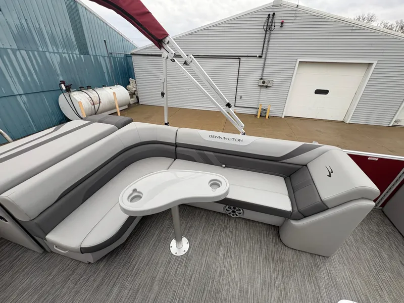Slide: The Image of 2020 Bennington 22 SLX pontoon boat with gray seating and a small table. - 24
