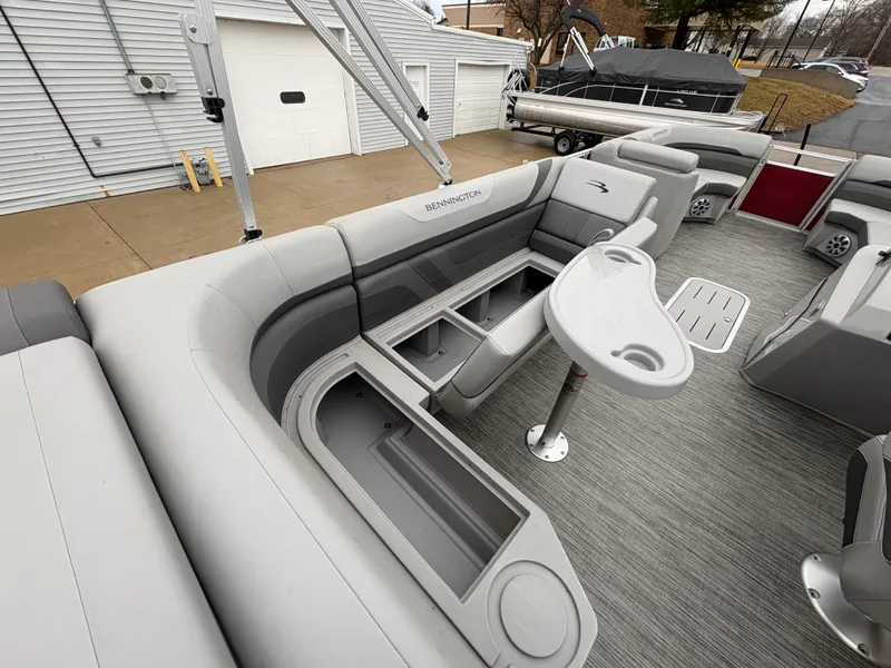 Slide: The Image of 2020 Bennington 22 SLX pontoon boat interior with gray seating and storage compartments. - 25