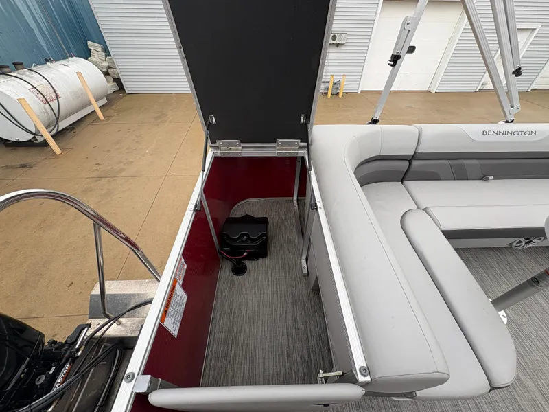Slide: The Image of Bennington 22 SLX 2020 boat interior with open storage compartment and seating. - 26