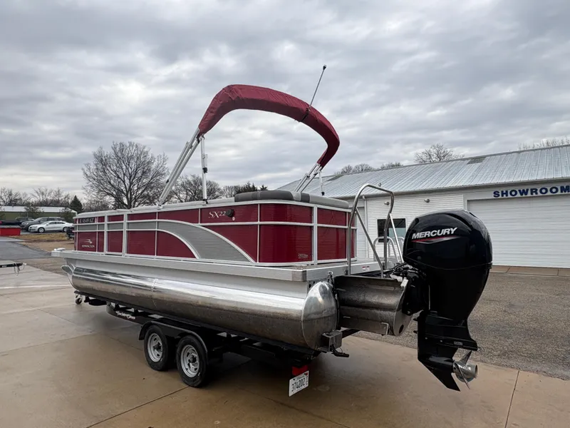 Slide: The Image of 2020 Bennington 22 SLX pontoon boat with Mercury outboard motor on trailer. - 3