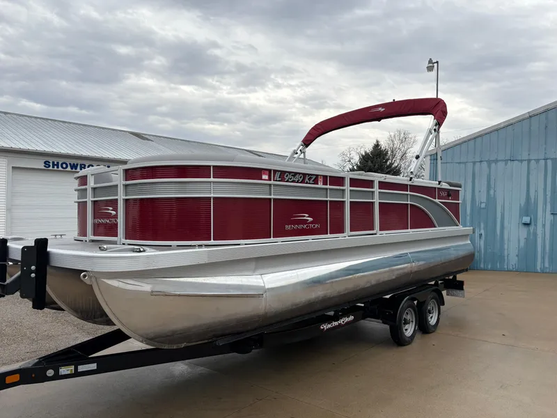 Slide: The Image of 2020 Bennington 22 SLX pontoon boat on trailer, red and silver, parked near showroom. - 5